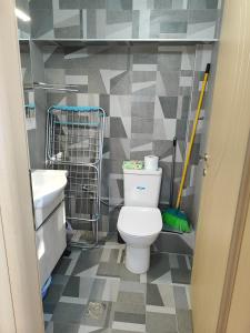 a bathroom with a toilet and a sink and a mop at My Flowers in Árgos Orestikón +35 photos