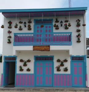 
a blue and white house with a blue door at Hostal Johnnier Macao Punta Cana in Punta Cana
