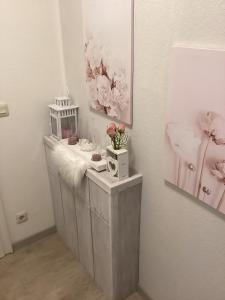 a white room with a table with flowers on it at Ferienwohnung Hankeln in Winterberg +57 photos