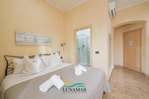 a hotel room with a bed with towels on it at Affittacamere Lunamar in La Spezia