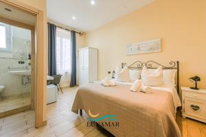 a bedroom with a large bed and a bathroom at Affittacamere Lunamar in La Spezia