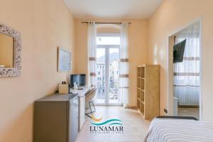 a hotel room with a desk and a bed at Affittacamere Lunamar in La Spezia