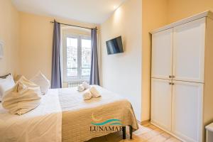 a bedroom with a bed with towels on it at Affittacamere Lunamar in La Spezia
