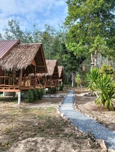 a row of huts in a resort with a path at Bansuan Lanta Maikaew in Ko Lanta