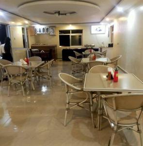 a restaurant with tables and chairs in a room at satelite view hotel in Webuye
