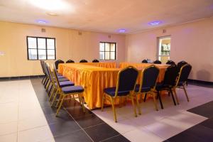 a conference room with a long table and chairs at satelite view hotel in Webuye