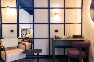 a room with a table and two chairs and a desk at Mercure Bucharest Cantemir in Bucharest