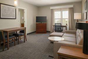 a living room with a couch and a table at Residence Inn by Marriot Clearwater Downtown in Clearwater +37 photos