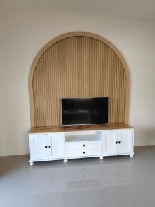 a flat screen tv sitting on top of a white entertainment center at รักตะวัน เวียงพันแสน in Hang Dong