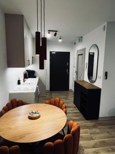 a kitchen with a table and chairs in a room at Marina Portovo in Gdańsk +28 photos