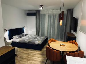 a bedroom with a bed and a table and chairs at Marina Portovo in Gdańsk
