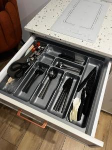 a drawer in a counter with a stove with tools at Marina Portovo in Gdańsk