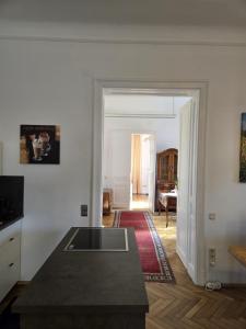 a kitchen with a table and a living room at Apartment Geidorf in Graz