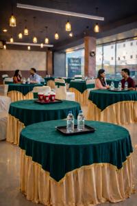 a group of people sitting at tables in a restaurant at Hotel JB Grand Residency Zirakpur Chandigarh # lift #Balcony Rooms # Banquet Hall # Family Rooms in Chandīgarh