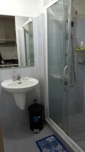 a bathroom with a sink and a shower at FinkSea @ Sea Residences in Manila
