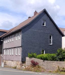 a blue house with a black roof at Harzer Bergstadthaus für Familien und Freunde in Sankt Andreasberg