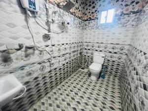 a bathroom with a toilet and a shower and a sink at Uthaya Guest House in Mullaittivu +37 photos