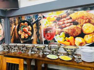 a table with a bunch of different types of food at Uthaya Guest House in Mullaittivu
