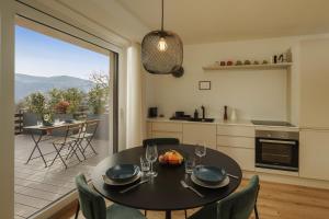 a kitchen and dining room with a table and chairs at Mountain View Suites in Tesimo