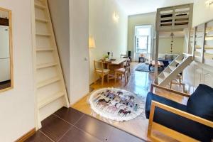 a living room with a staircase and a dining room at Corvin Museum View Studio in Budapest