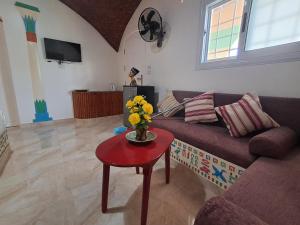 a living room with a couch and a table with flowers at ATON PALACE Luxor in Luxor