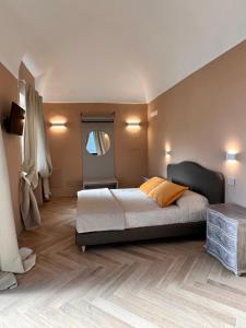 a bedroom with a large bed and a window at L'Orangerie in Morozzo +9 photos