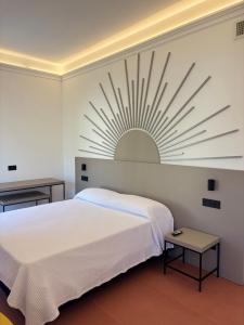 a white bedroom with a white bed and a white wall at Hotel Sole in Maiori