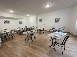 a room with tables and chairs in a room at Le grand cerf Blain in Blain