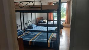 two bunk beds in a room with a hallway at Amaretto Hostel in Surat Thani