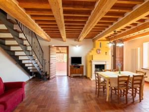 a living room with a table and chairs and a couch at Apartment in a farmhouse with 2 swimming pools in Cagli