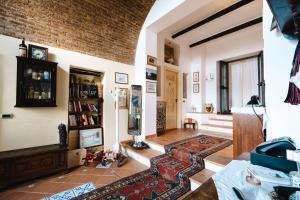 a living room with a brick wall at Tenuta Rasocolmo in Messina