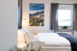 a hotel room with a bed and a window at Heu22 Herbstgold in Farchant