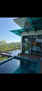 a swimming pool in front of a house at Love koh tao villa 2 in Koh Tao