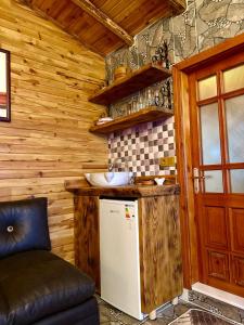 a small kitchen with a refrigerator and a counter at İsgobya Dağ Evleri 108 in Macka