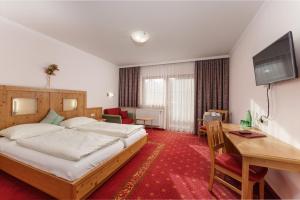 a hotel room with a bed and a desk at Hotel Moser in Schladming +83 photos