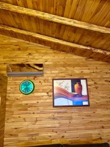 a clock on a wooden wall with a picture at İsgobya Dağ Evleri 108 in Macka +8 photos