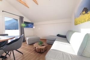 a living room with a couch and a table at Heu22 Heuboden in Farchant