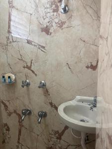 a bathroom with a toilet and a sink at Varson Stay in Pondicherry +9 photos