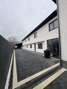 an empty street next to a white building at IUGAs RESIDENCE in Sighetu Marmaţiei
