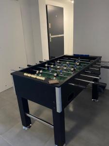 a foosball table in a room with at Apartament SUNNY Rusinowo in Rusinowo