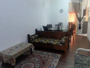 a living room with a couch and a table at Shayus Homestay in Kampong Alor
