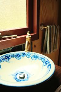 a bathroom sink with a blue and white sink at Rancho Relaxo Tiny House - in town sanctuary in Margaret River Town