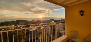 a balcony with a view of the sunset at קיבוץ שדה נחום Green House in Sede Naẖum