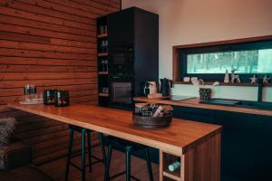 a kitchen with a counter and a wooden wall at Cozy Chalet in Smolné Pece +36 photos