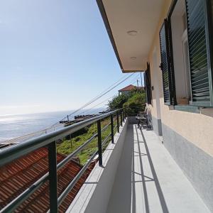 a balcony with a view of the ocean at Yellow Owl II - Bedroom III in Campanário