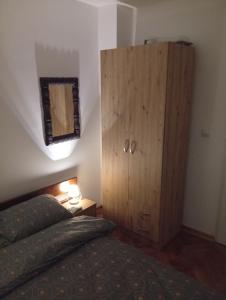 a bedroom with a bed and a wooden cabinet at Vila Jezerce Zlatibor Zbojštica in Užice +36 photos