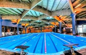 a large swimming pool with a large ceiling at Beachfront Central Apartments in Durrës