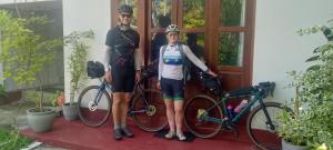 two people standing in front of a house with their bikes at Villa Ocean Whisper in Bentota