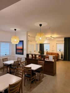 a dining room with tables and chairs and a couch at A-Termal Palić in Palić