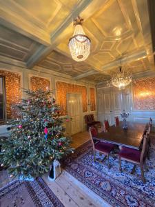 a christmas tree in a dining room with a table at Solvang in Assens